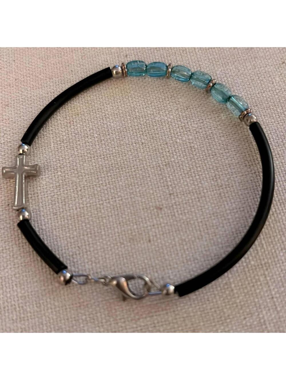 Silver cross and pale blue beaded bracelet w rubber cord and silver beads